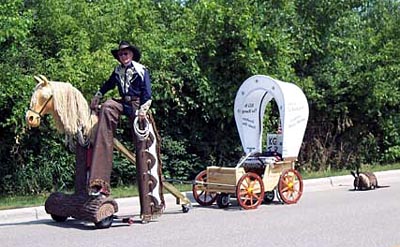 Stilt-walking Cowboy parade rig